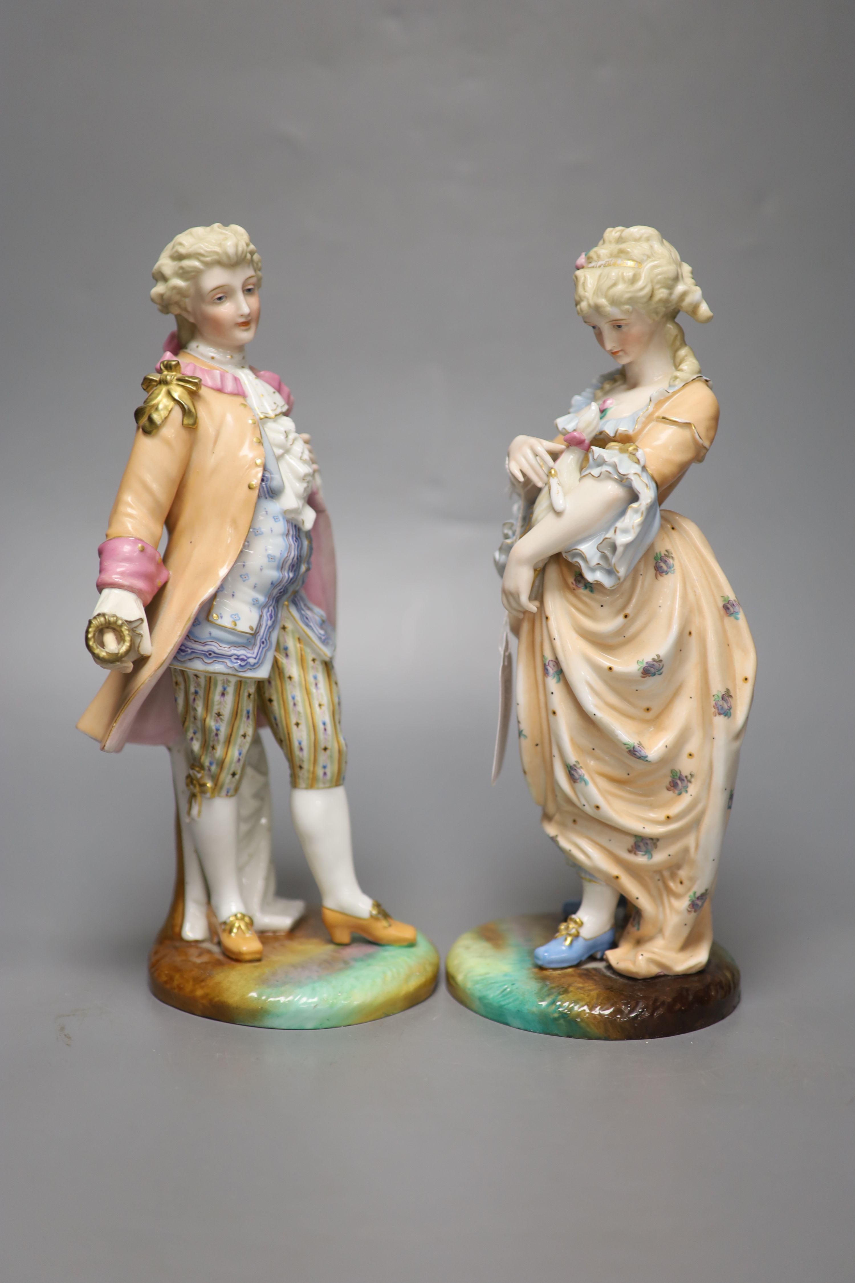 A Royal Worcester leaf-decorated vase, a Continental vase with amorini and a pair of figures of lovers (faults), tallest 29cm